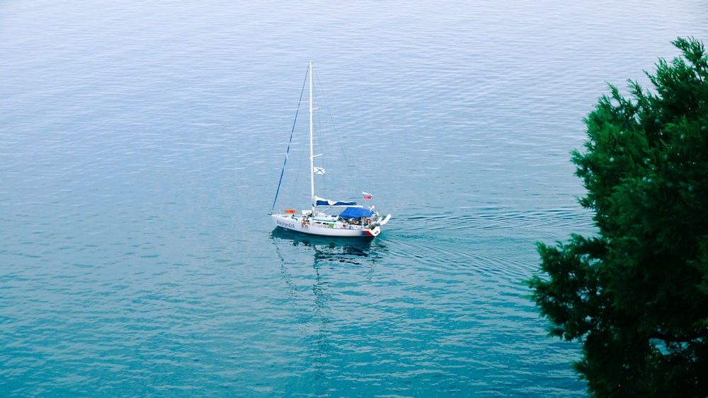 a small sailboat floating on a large body of water