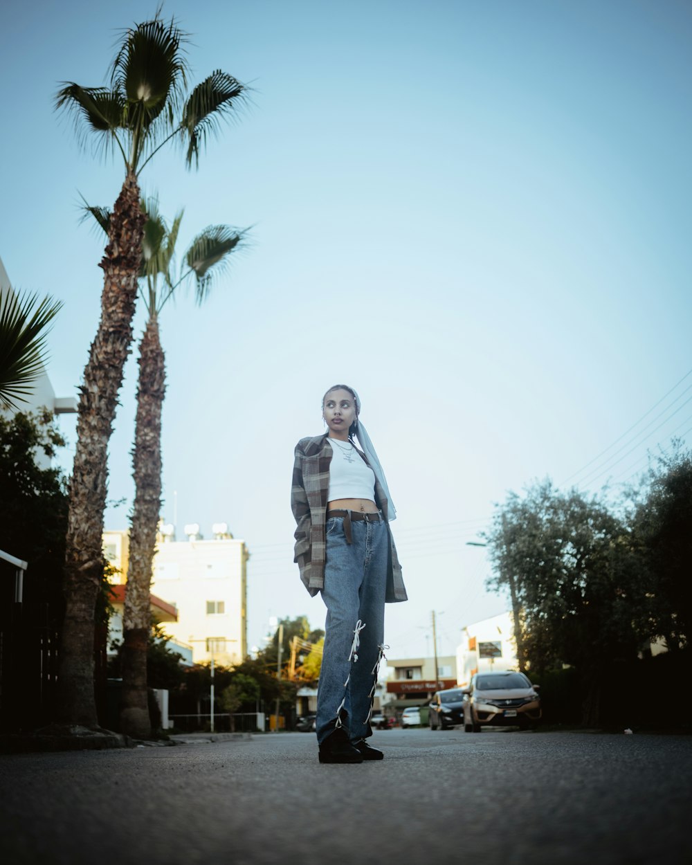 a woman standing in the middle of a street