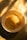 A bowl of cooked instant noodles is placed on a surface bathed in warm, golden sunlight. The light creates soft shadows and highlights on the noodles, enhancing their texture and inviting a sense of warmth.