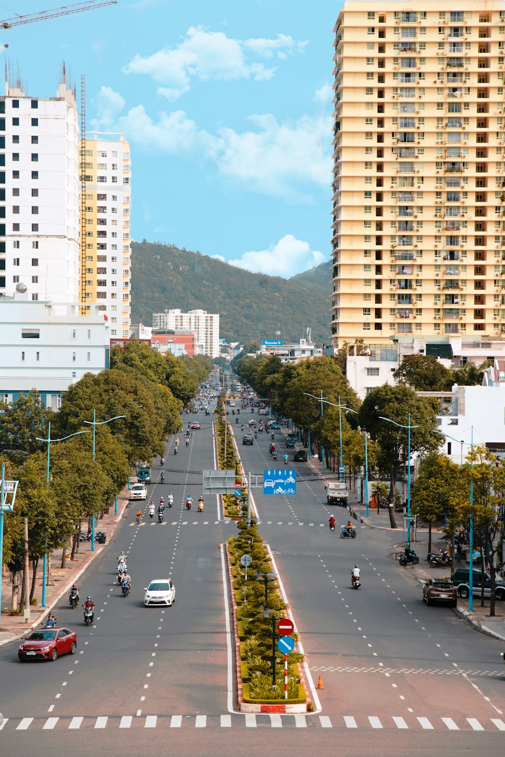 a view of a city street with tall buildings in the background