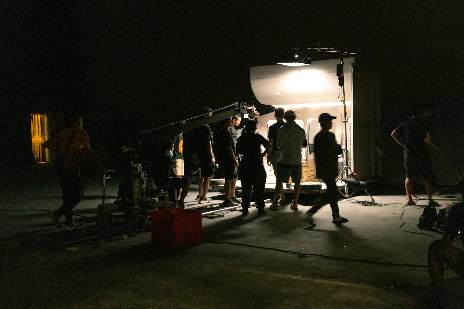 Crew around a camera in near darkness on a night shoot
