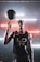 A basketball player in a black jersey with 'LDN' written on it holds a spinning basketball on one finger. The background features a modern, industrial look with horizontal neon lights in red and white, creating a dynamic atmosphere.