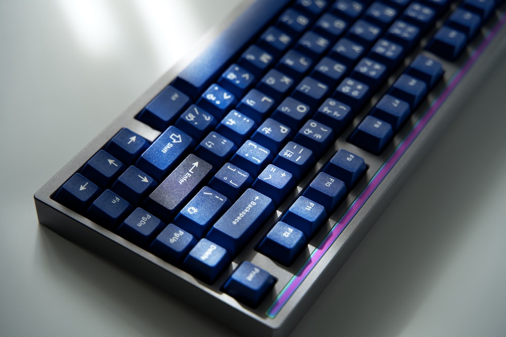 a close up of a blue keyboard on a table