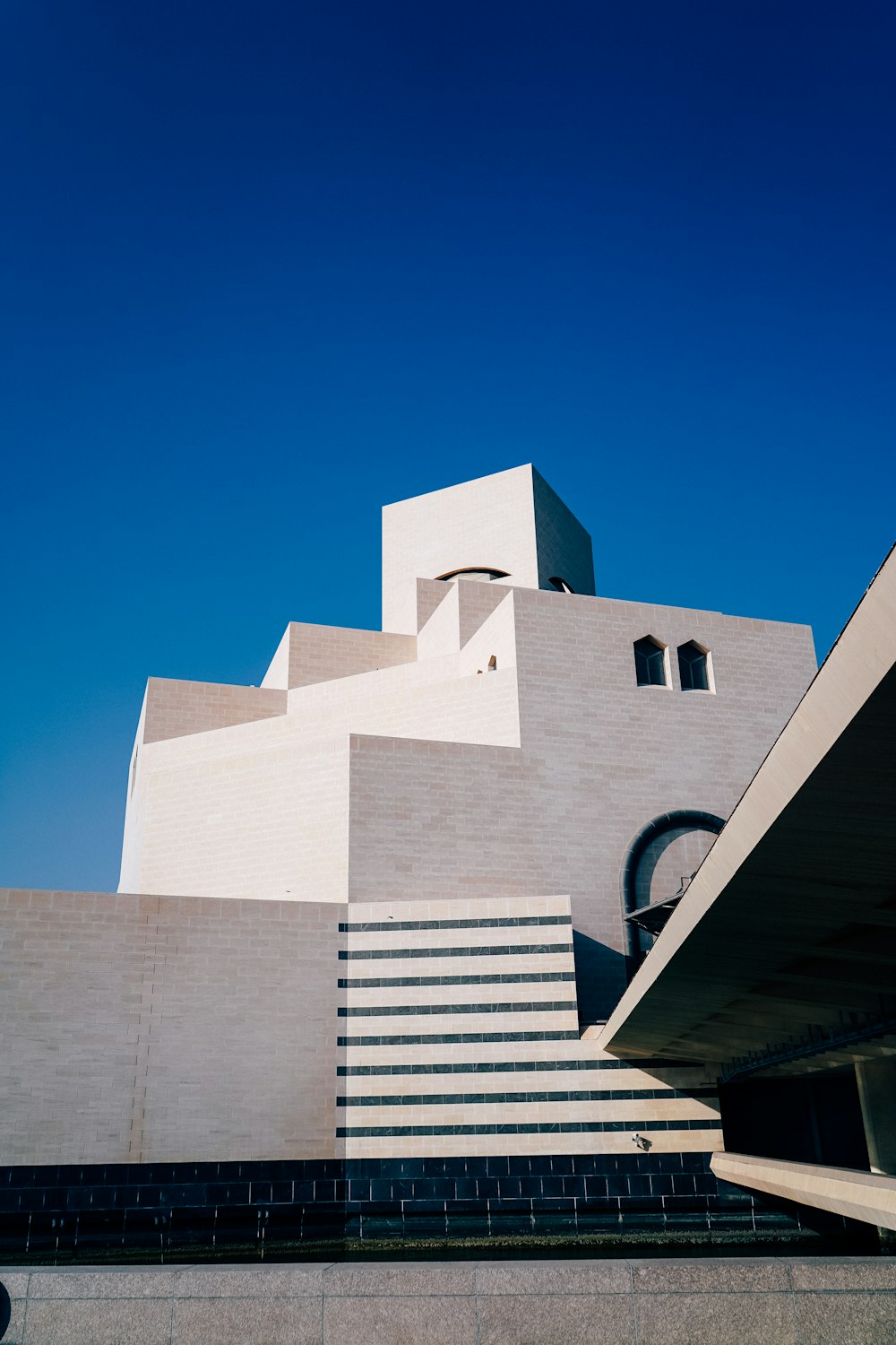 a white building with a staircase leading up to it