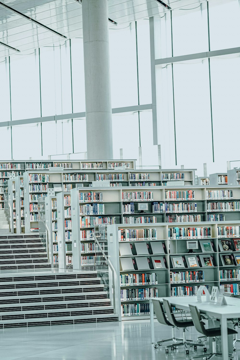 a library filled with lots of books and stairs