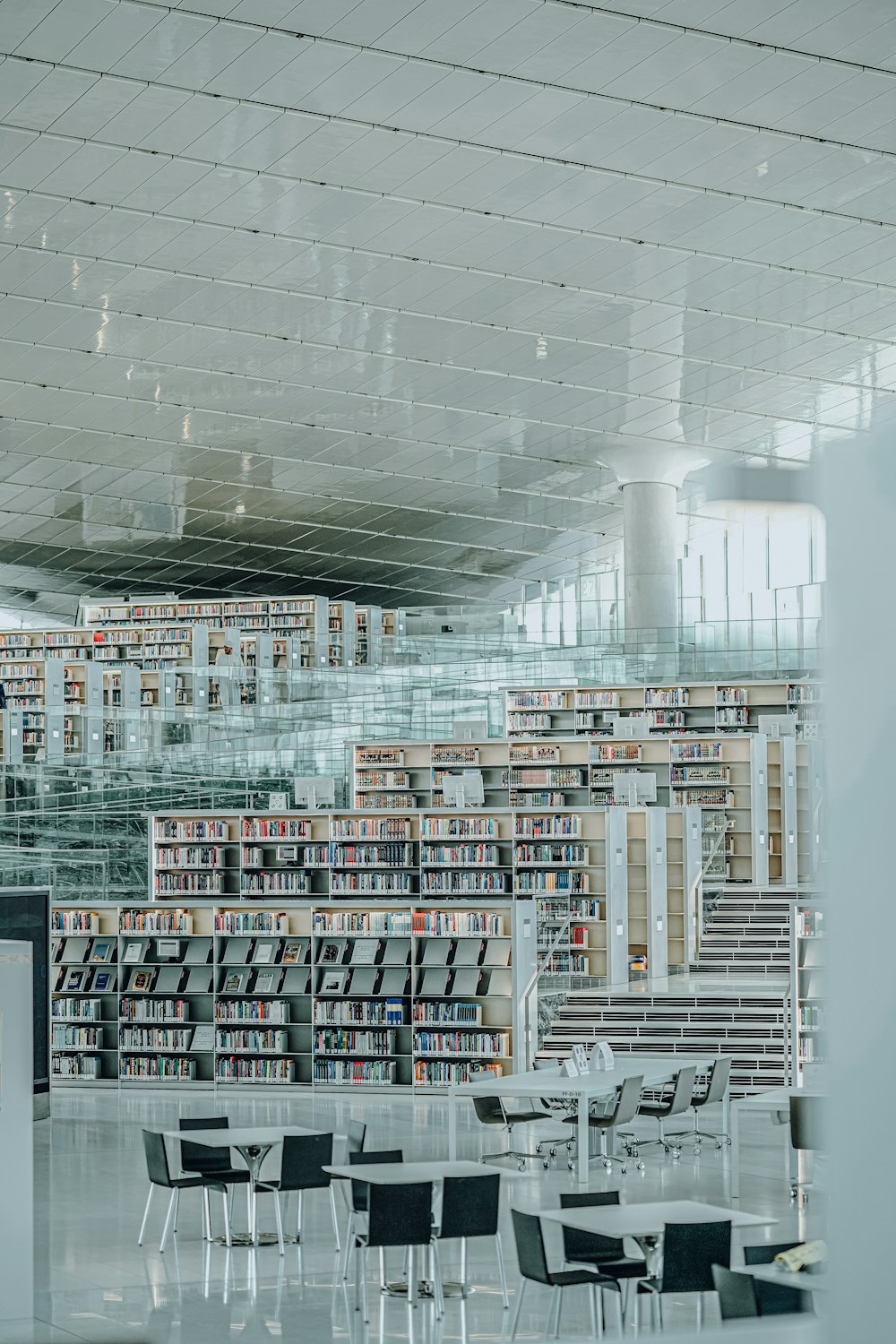 a library filled with lots of books and tables