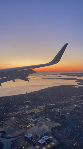 Aerial view of Dubai skyline at sunset from a plane window.