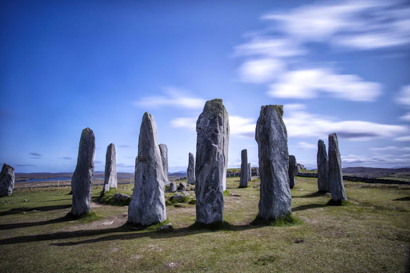 Ancient standing stone circle in a Scottish field under a moody sky, illustrative photo