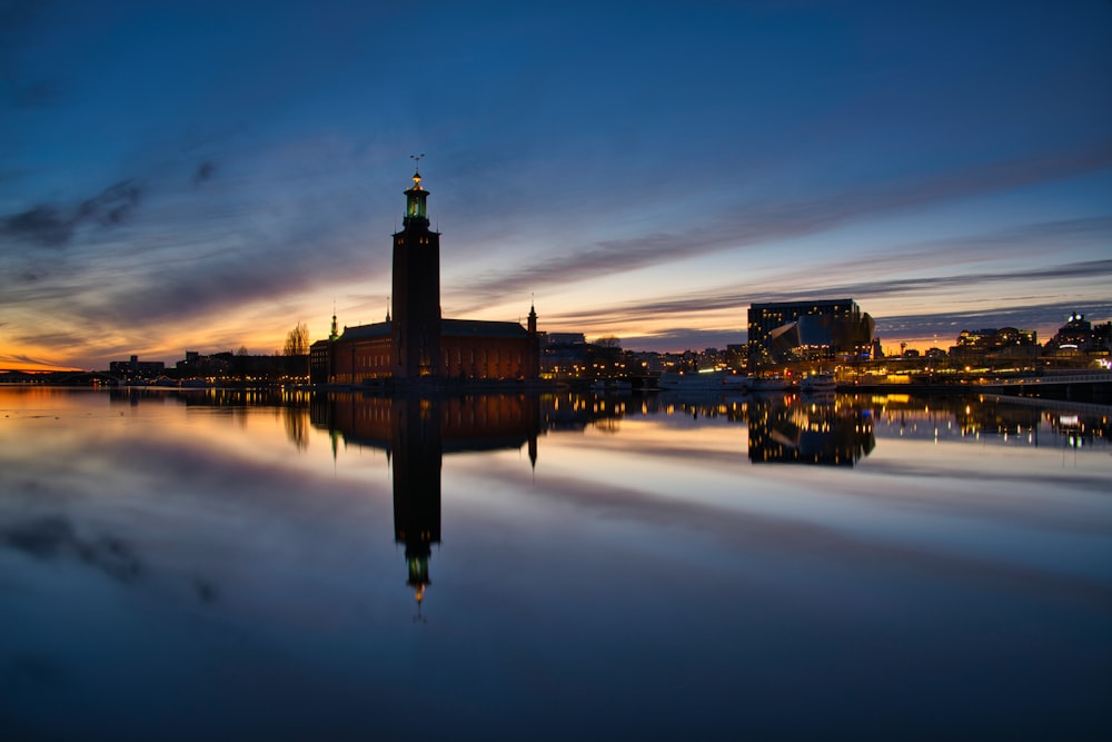 a large clock tower sitting on top of a lake