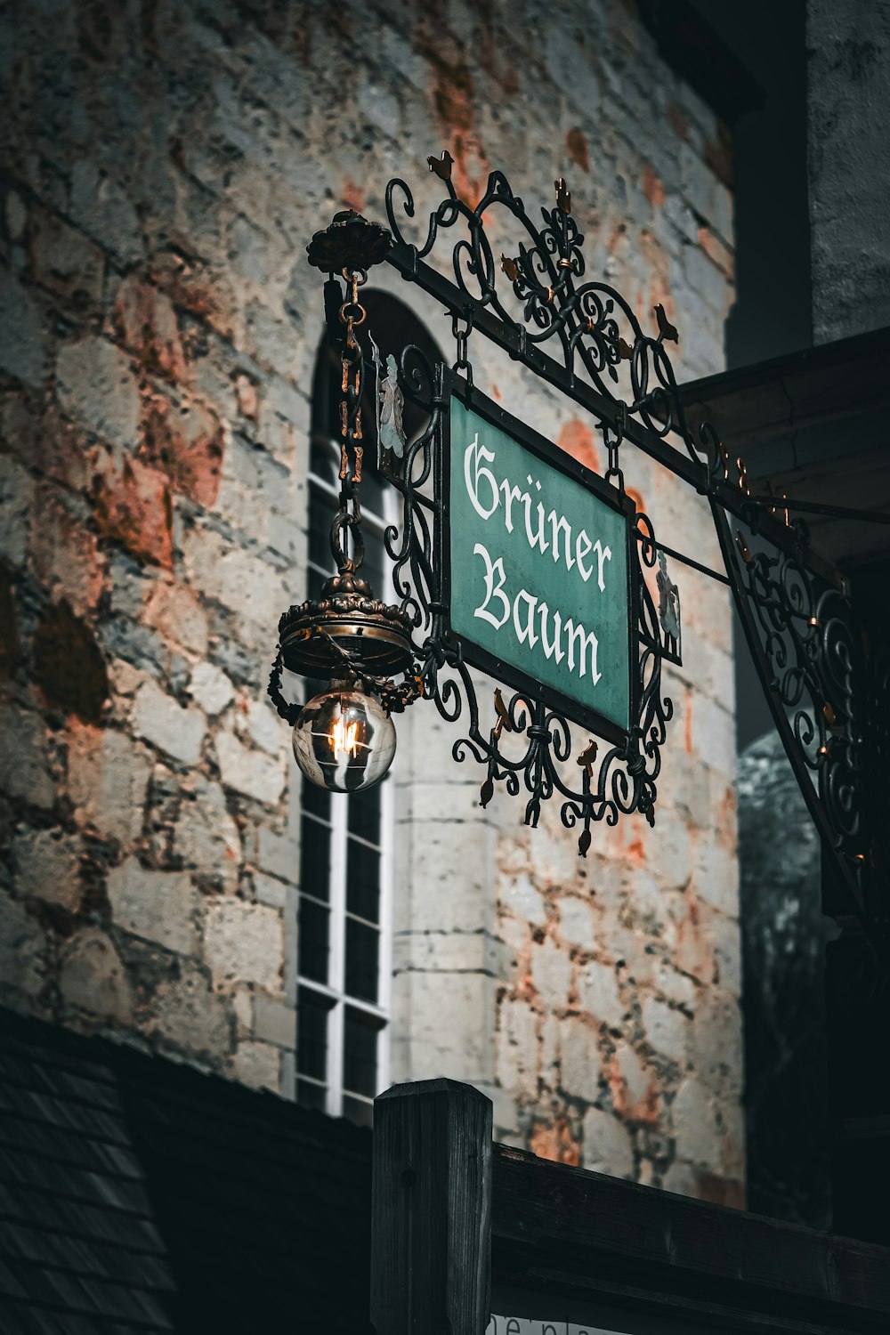 a street sign hanging from the side of a brick building