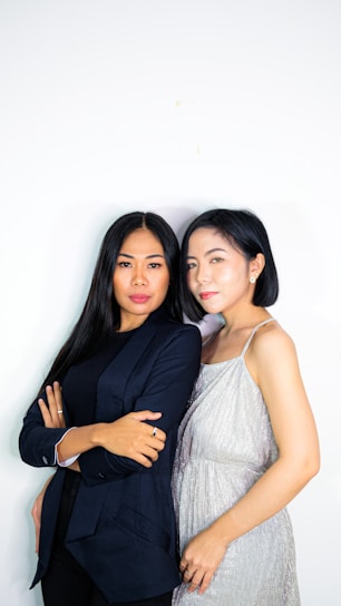 Two confident women standing together, representing leadership and determination.