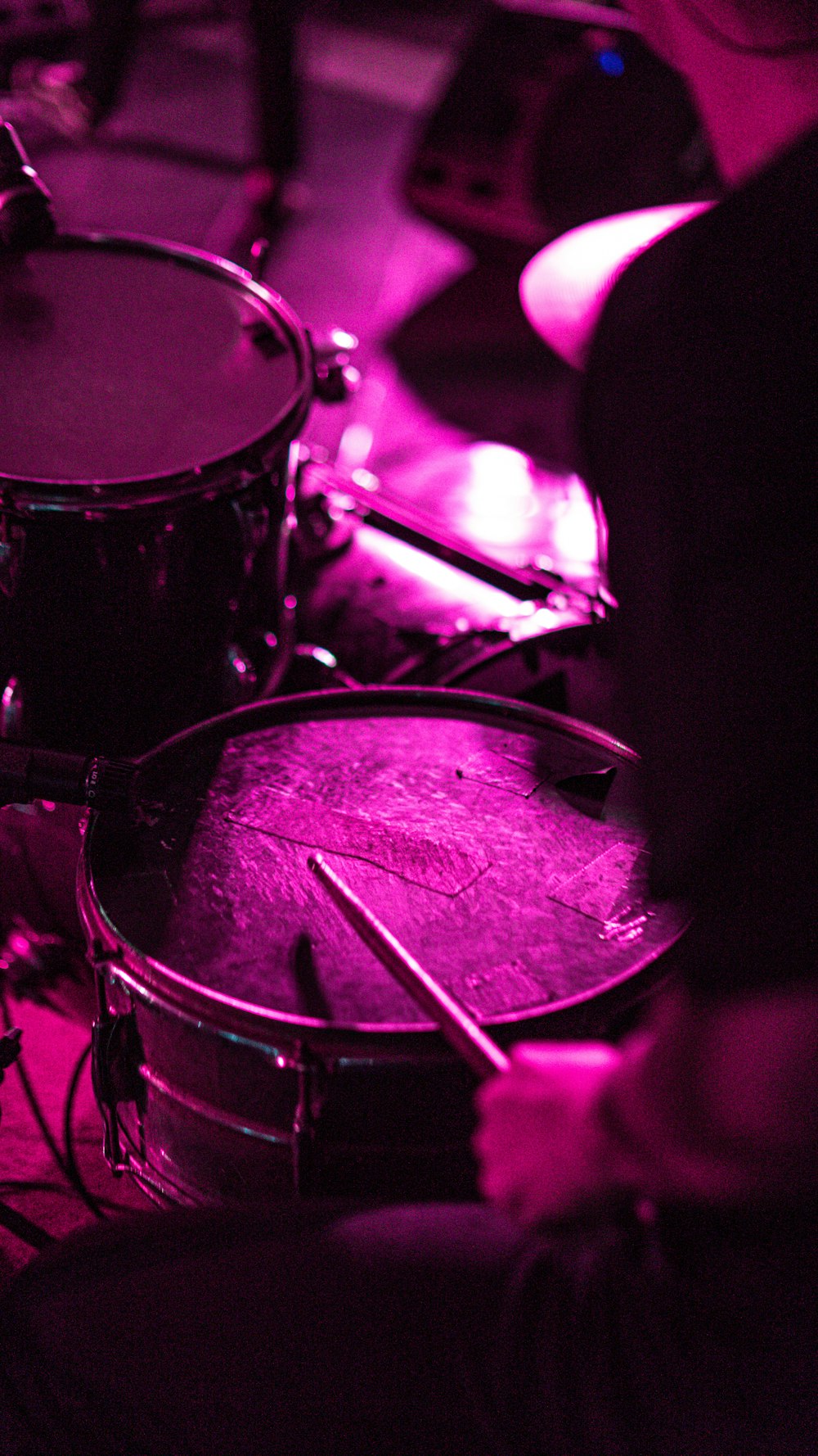 a group of people playing drums in a dark room