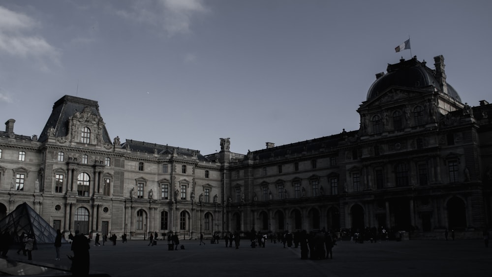 a large building with many people walking around it