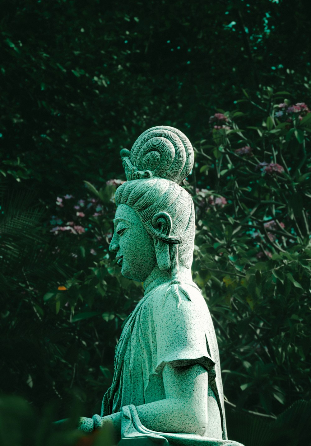 a statue of a woman with a flower in her hair