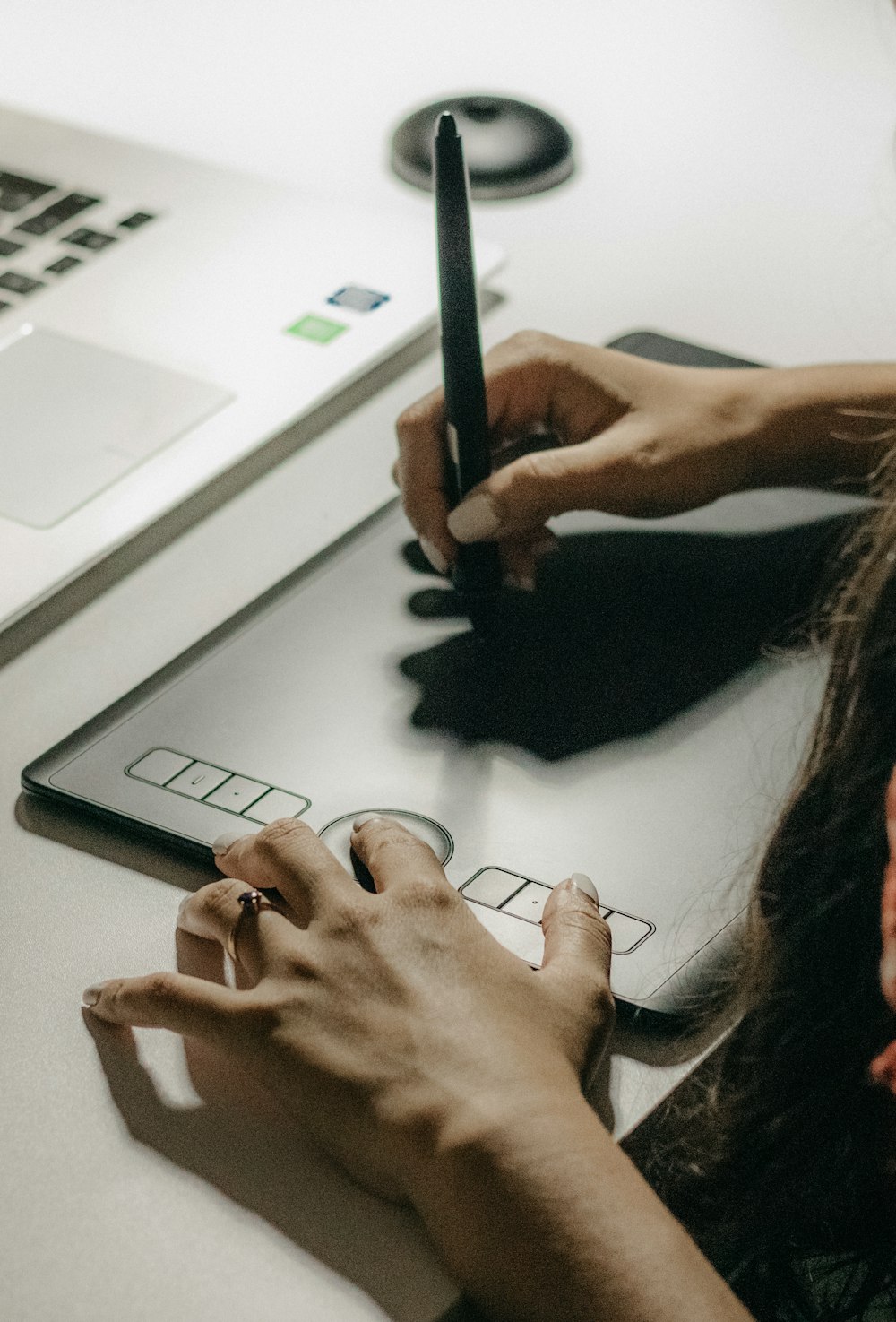 a woman sitting at a desk writing on a laptop