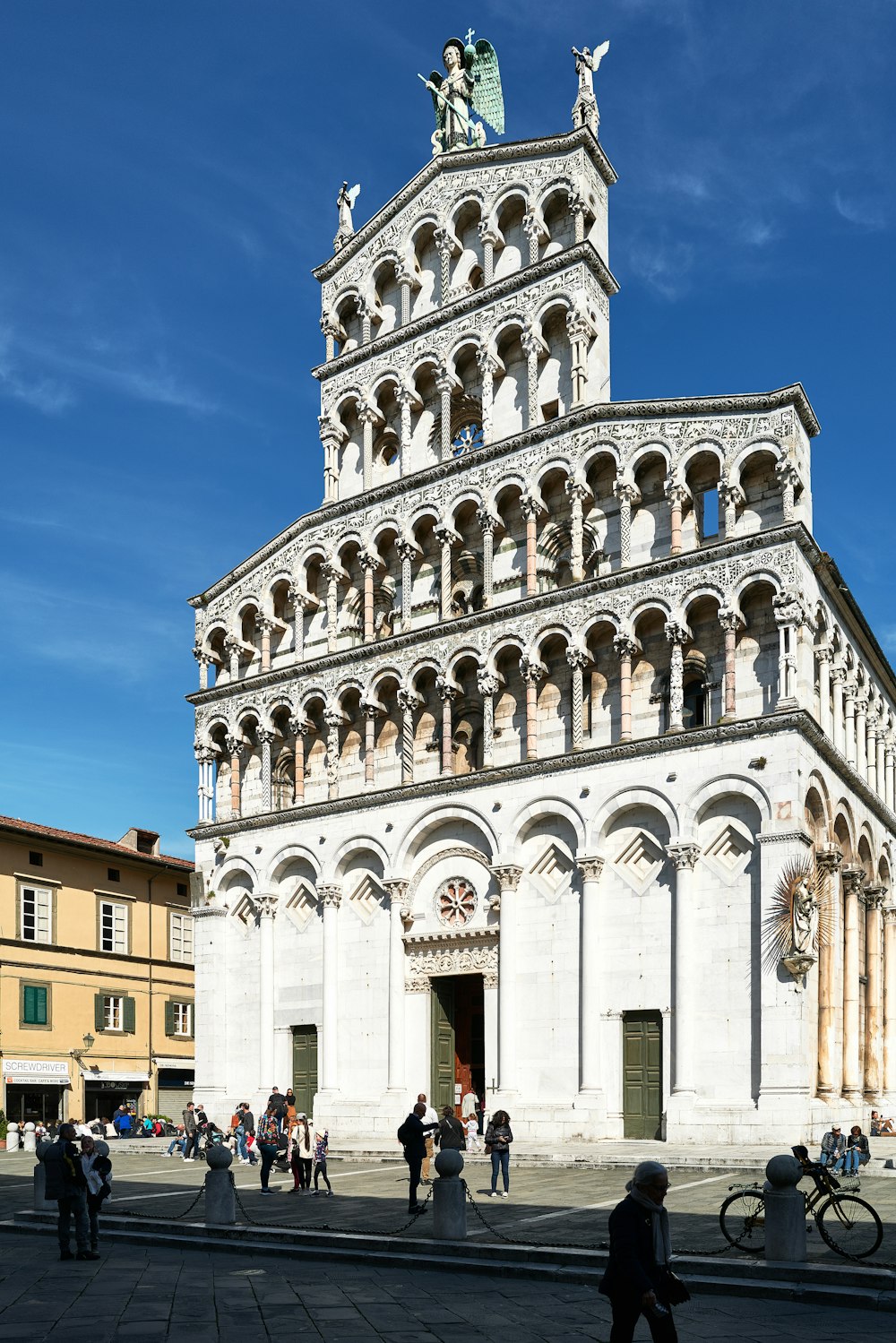 a tall white building with a clock tower on top of it