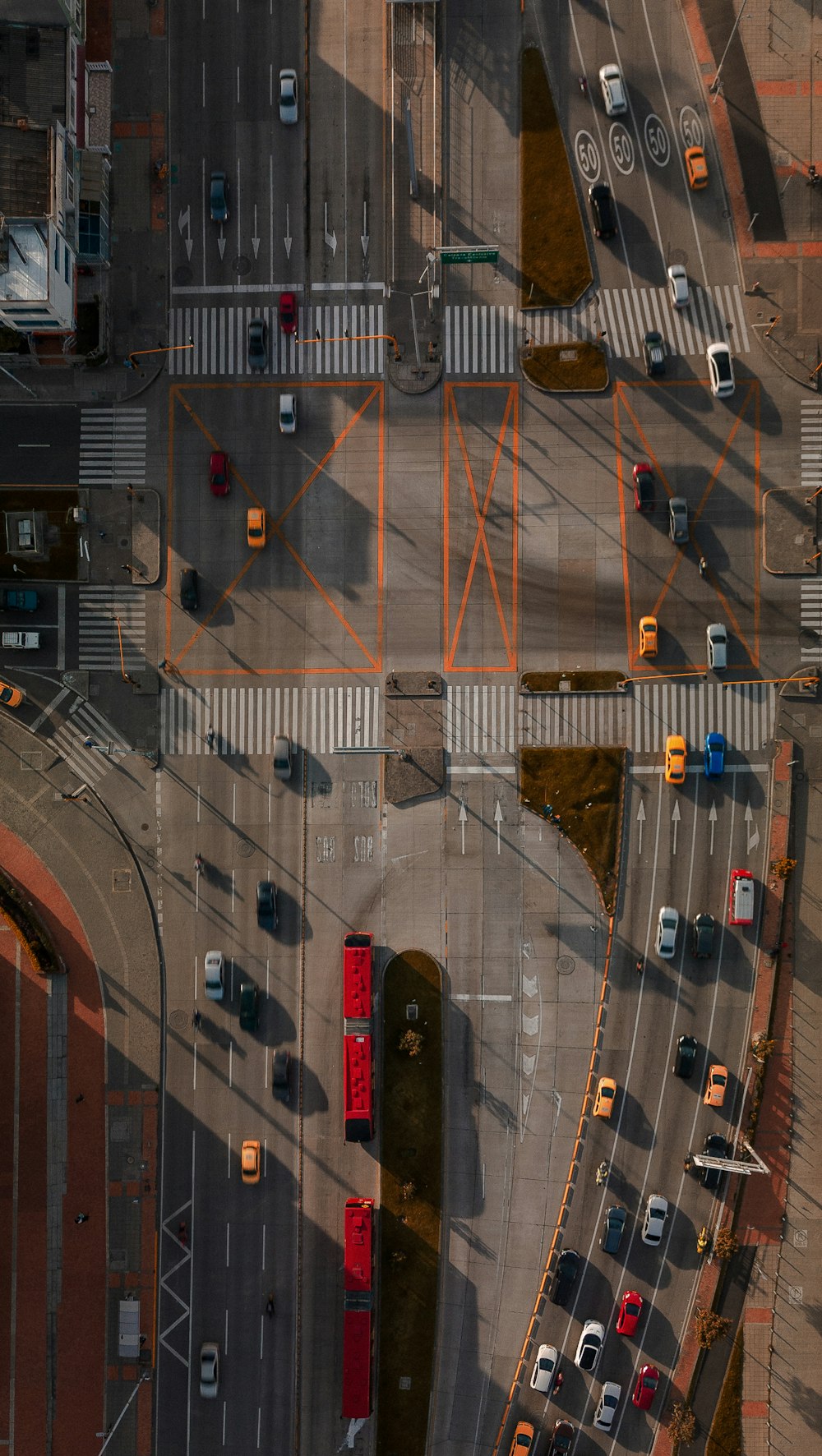 an aerial view of an intersection with cars and trucks