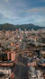 an aerial view of a city with mountains in the background