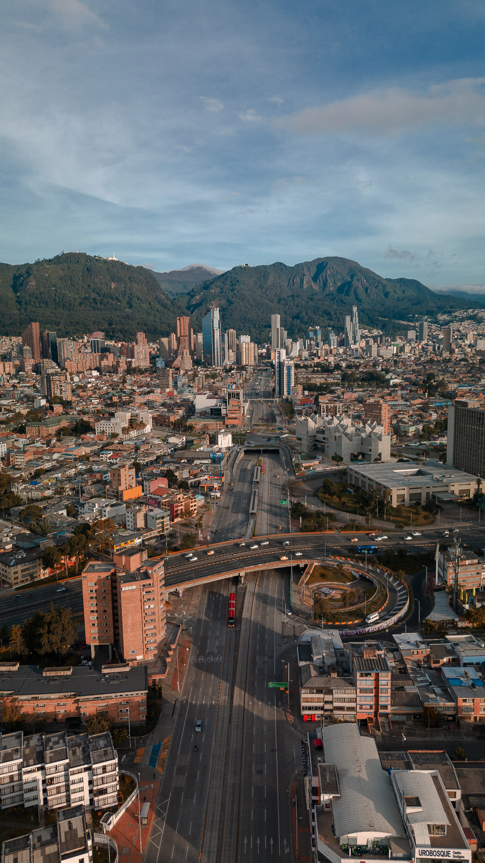 an aerial view of a city with mountains in the background