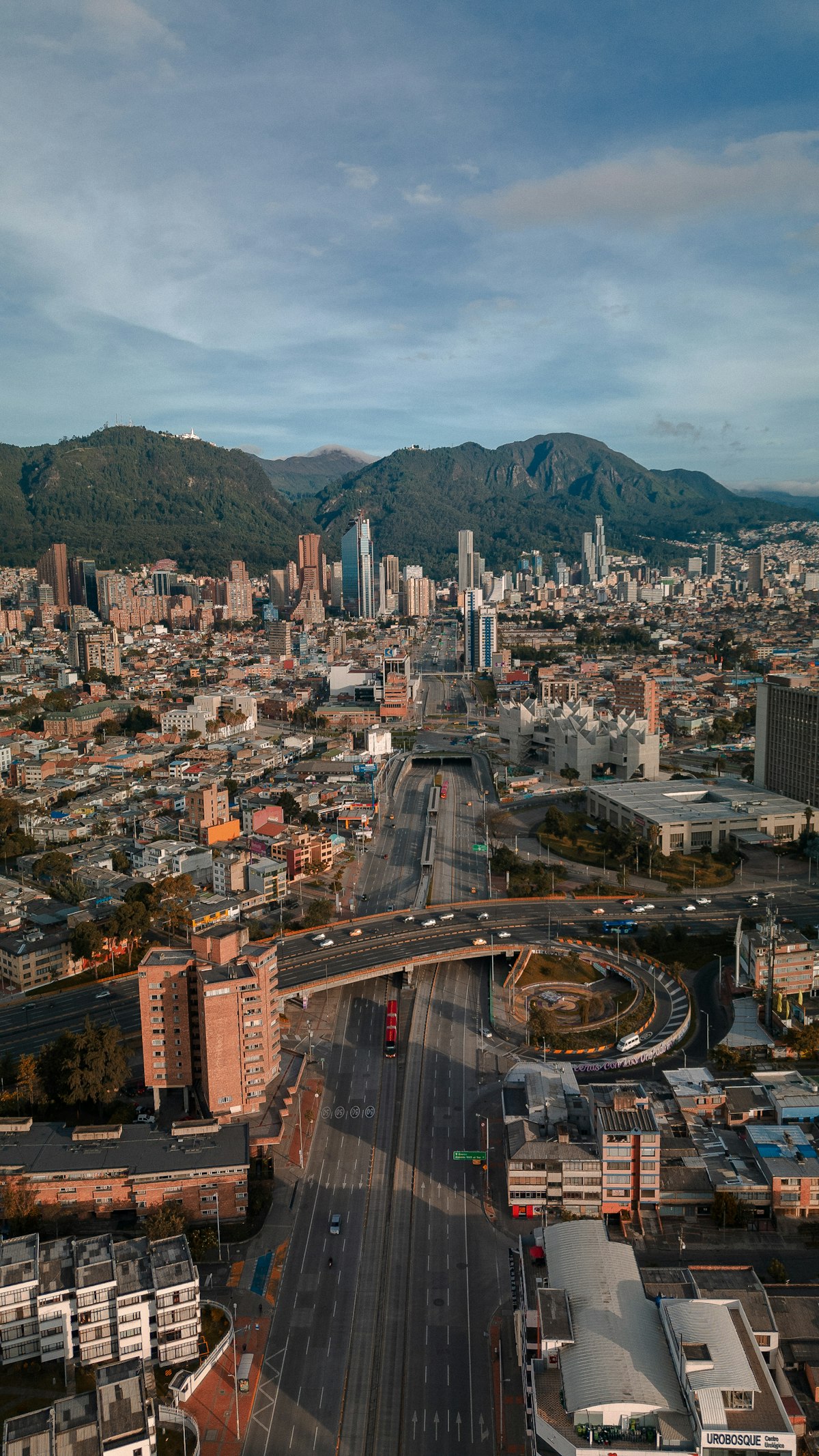 Aerial view of high-rise towers in Bogotá's Teusaquillo district framed by green Andes foothills