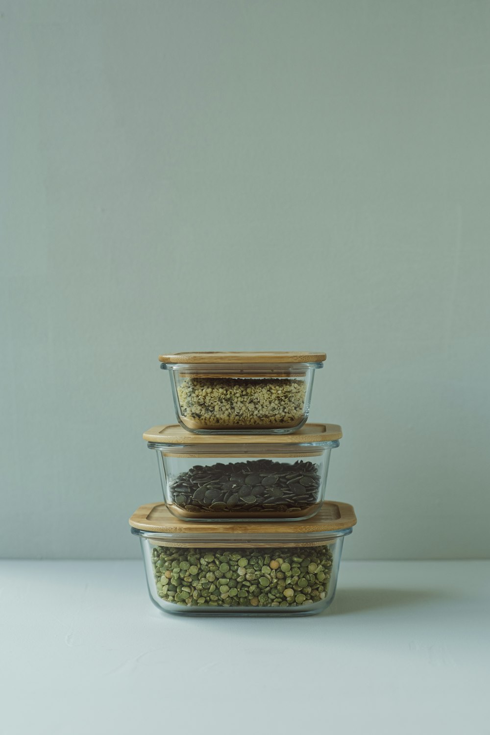 three glass containers filled with food on top of a table