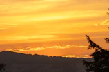 A sunset view over the rolling Sierras Bayas landscape with warm golden hues illuminating the valley.