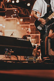 a man playing a guitar on a stage