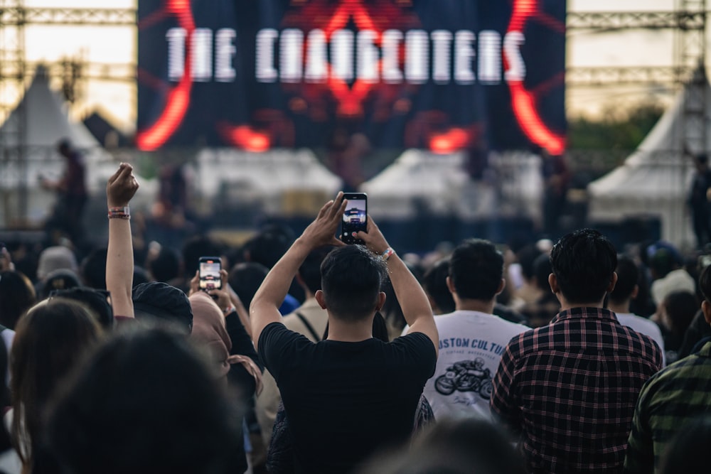 a group of people standing in front of a stage