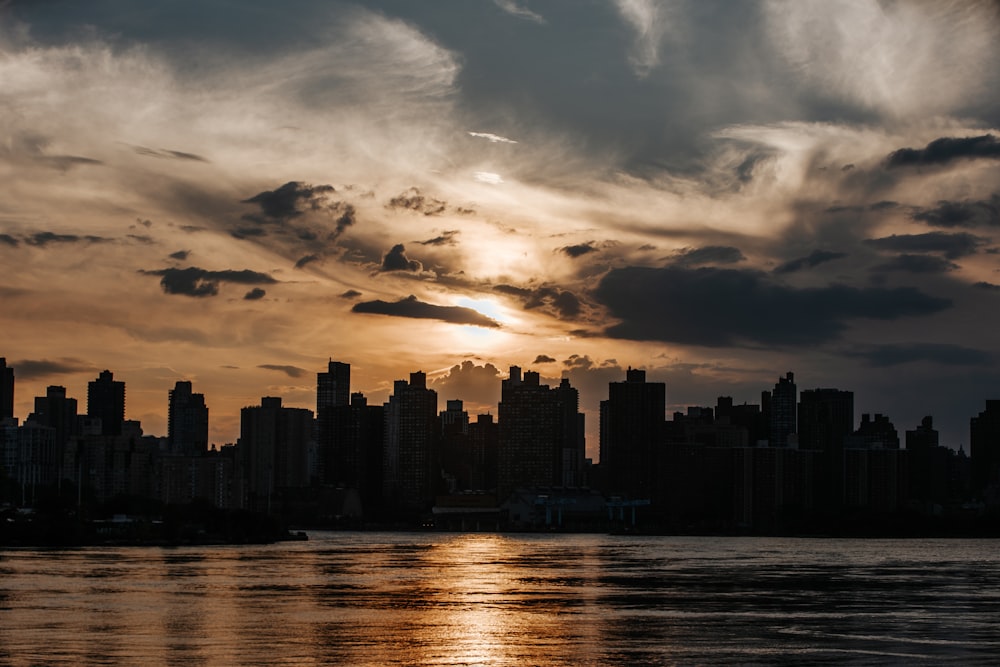 the sun is setting over a large city