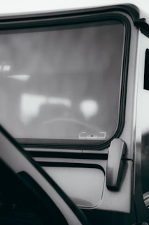 Side view of a bronze-tinted windshield perfectly curved to match a cabin cruiser.