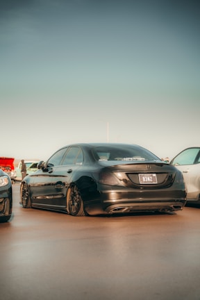 Side view of a sleek black sedan with spotless, gleaming windows.