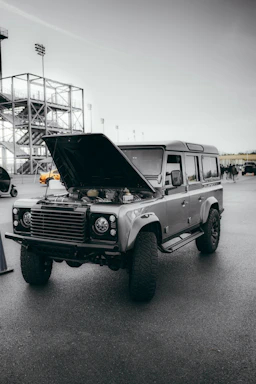 Close-up of a rugged offroad vehicle engine with a custom adapter plate installed.