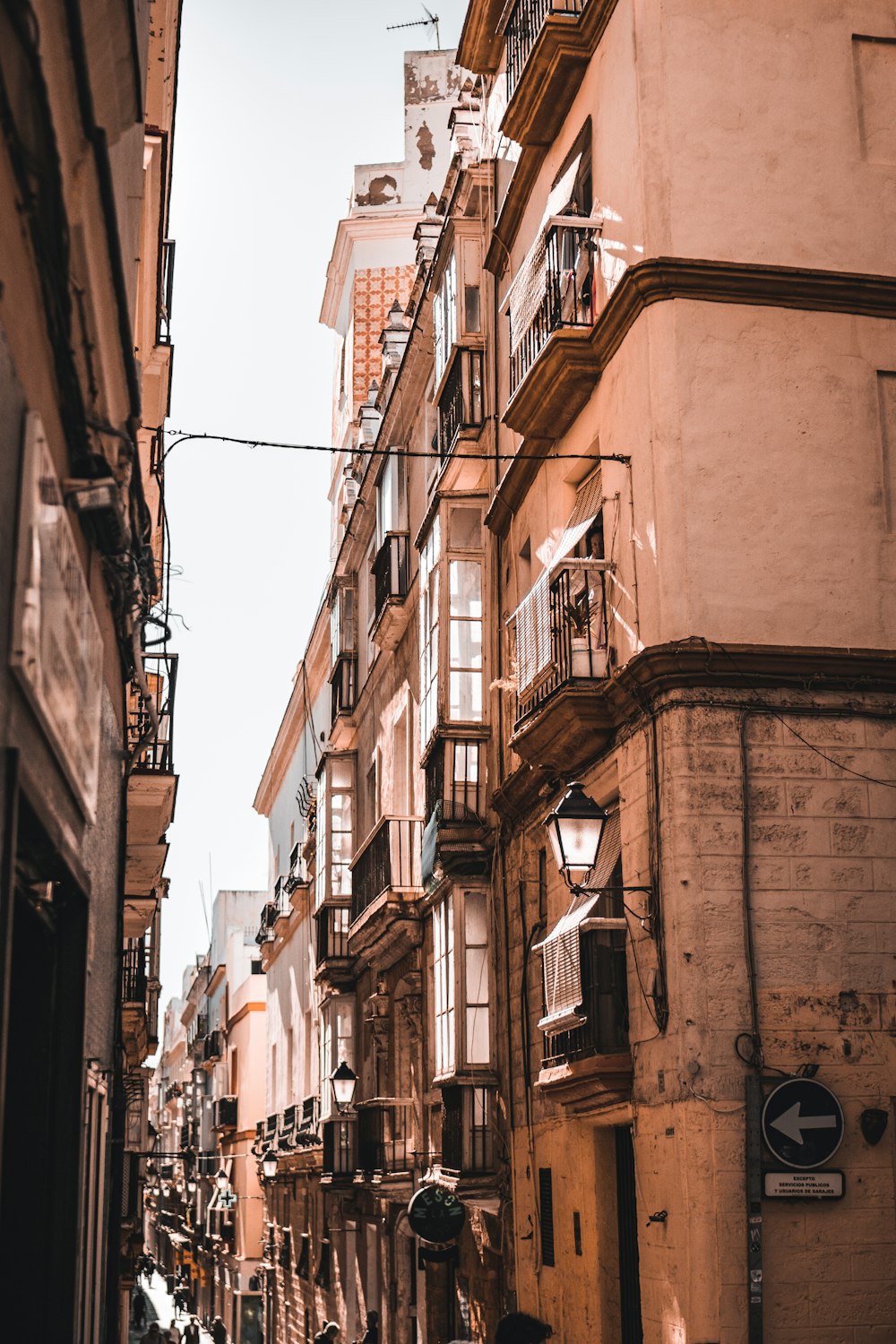 a person walking down a street next to tall buildings