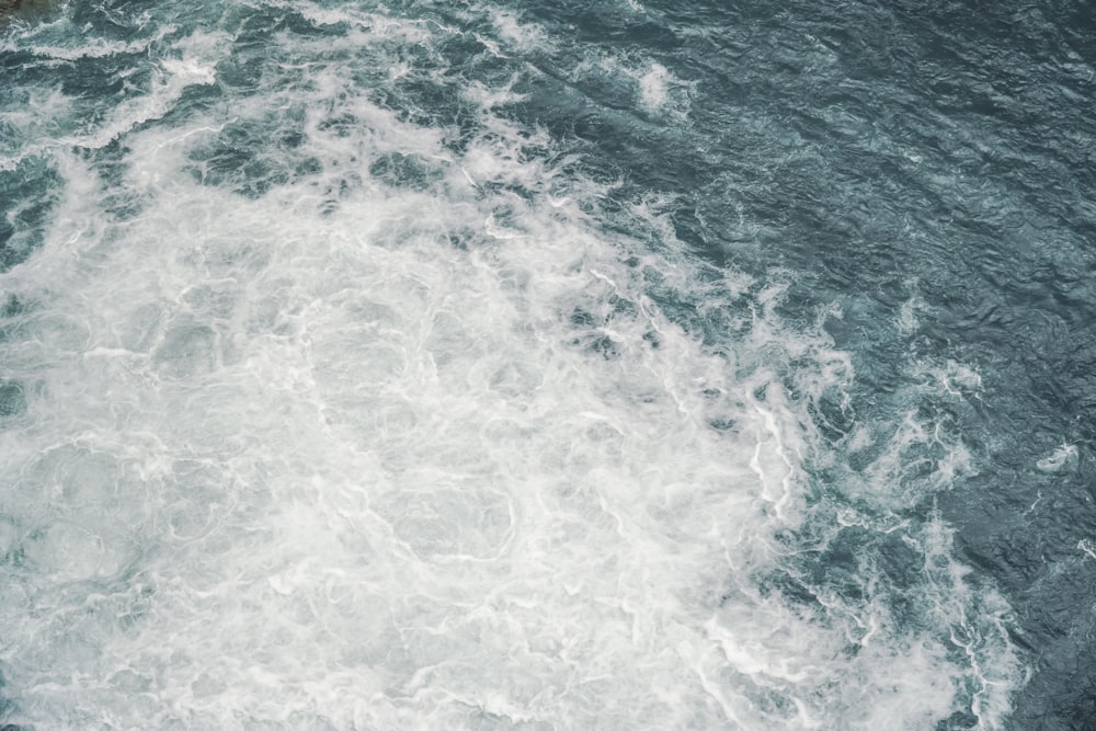 a man riding a surfboard on top of a wave in the ocean