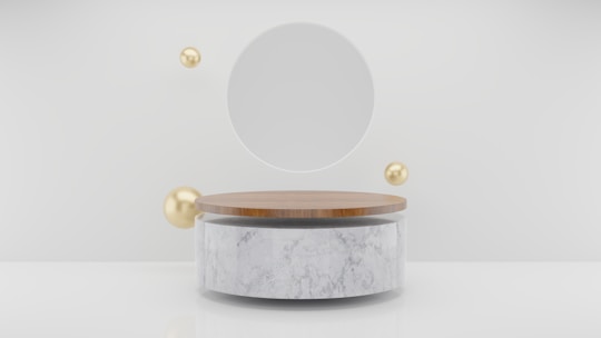 a round mirror sitting on top of a white table