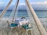 An elegant dining setup on a private beach.