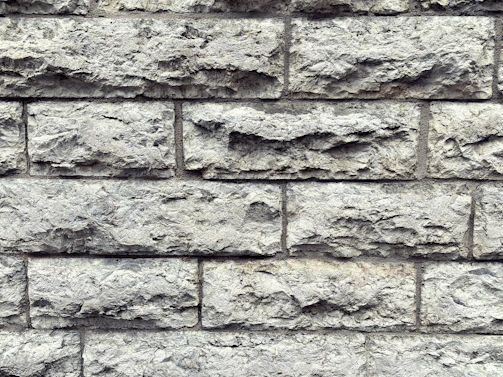 Close-up of rugged natural stone blocks freshly mined in Udaipur, showcasing their raw texture and earthy tones.