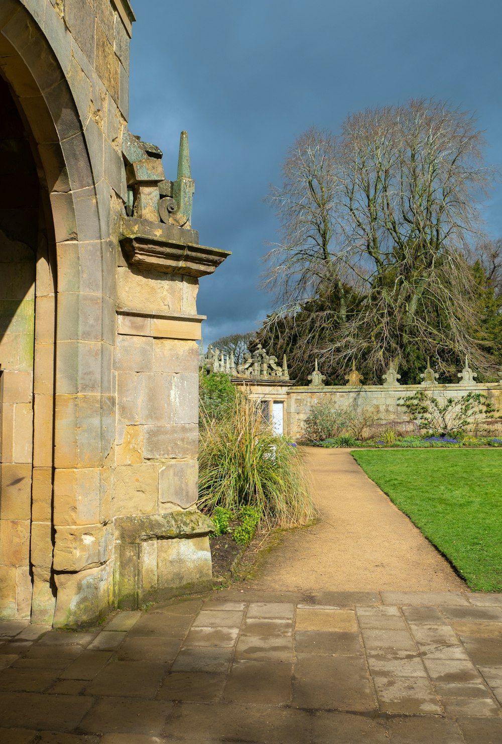 a stone building with a walkway leading to it