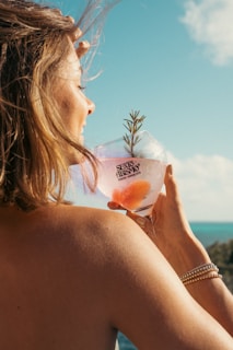 A person enjoying a drink from a stylish tumbler outdoors.