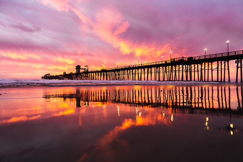A pier that is next to a body of water photo – Free Oceanside Image on  Unsplash