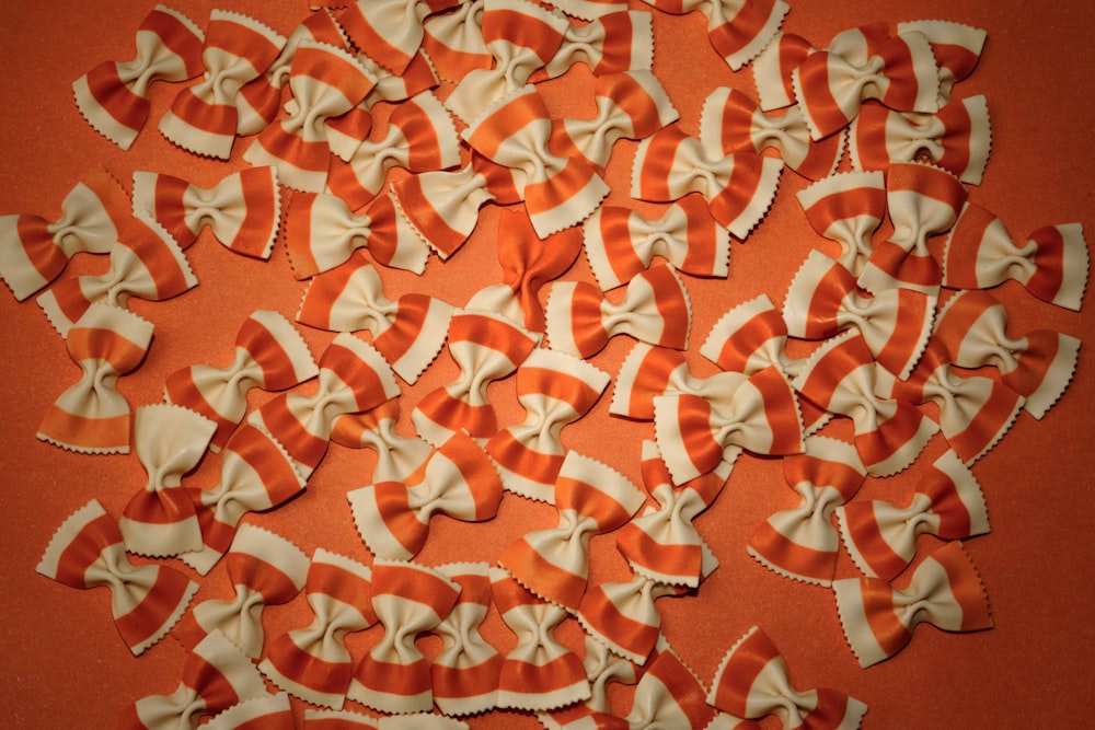 a bunch of orange and white bows on an orange background