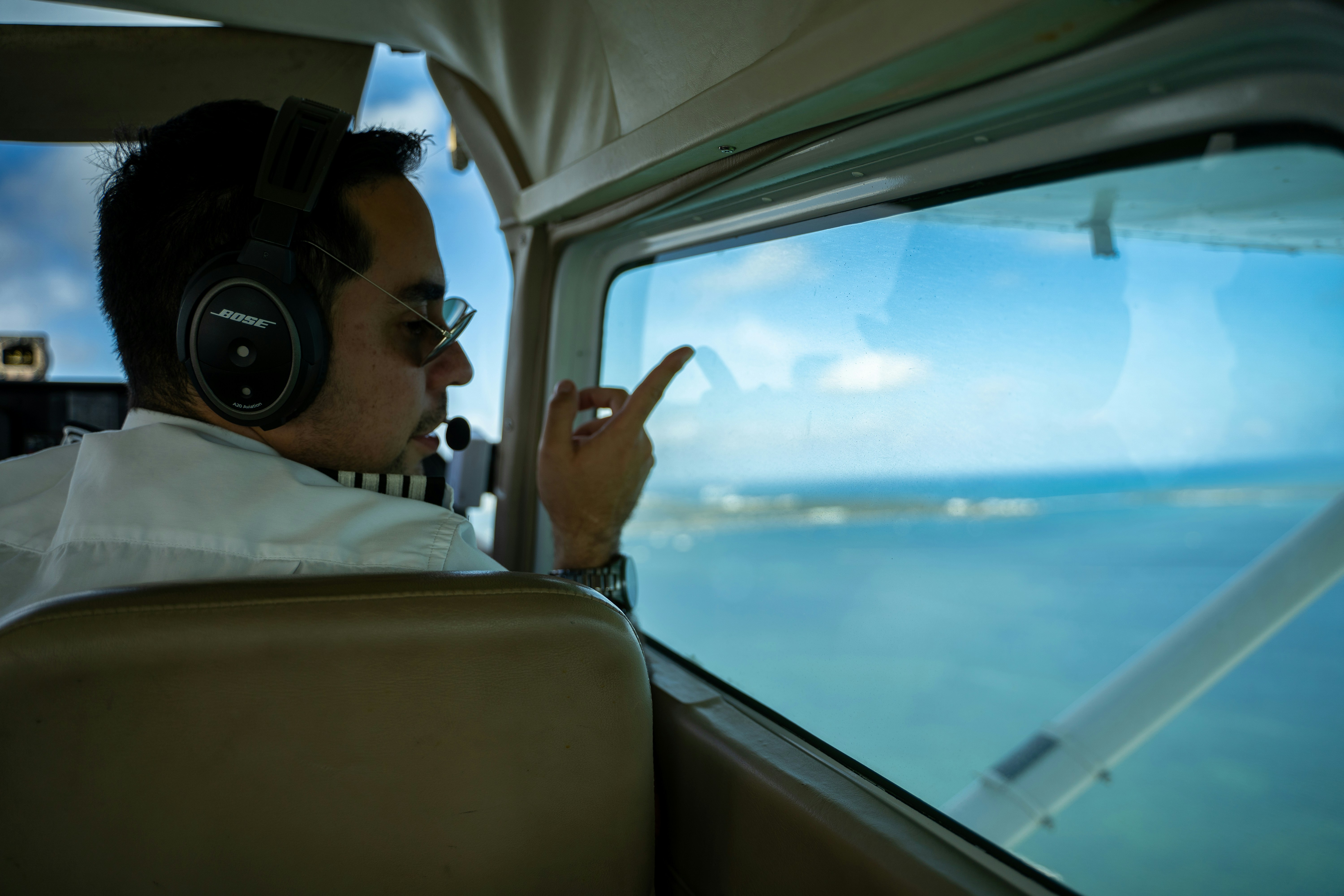 a man sitting in a plane with headphones on, 