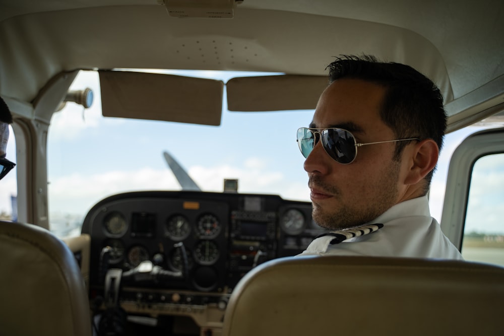 a man and a woman sitting in the cockpit of a plane