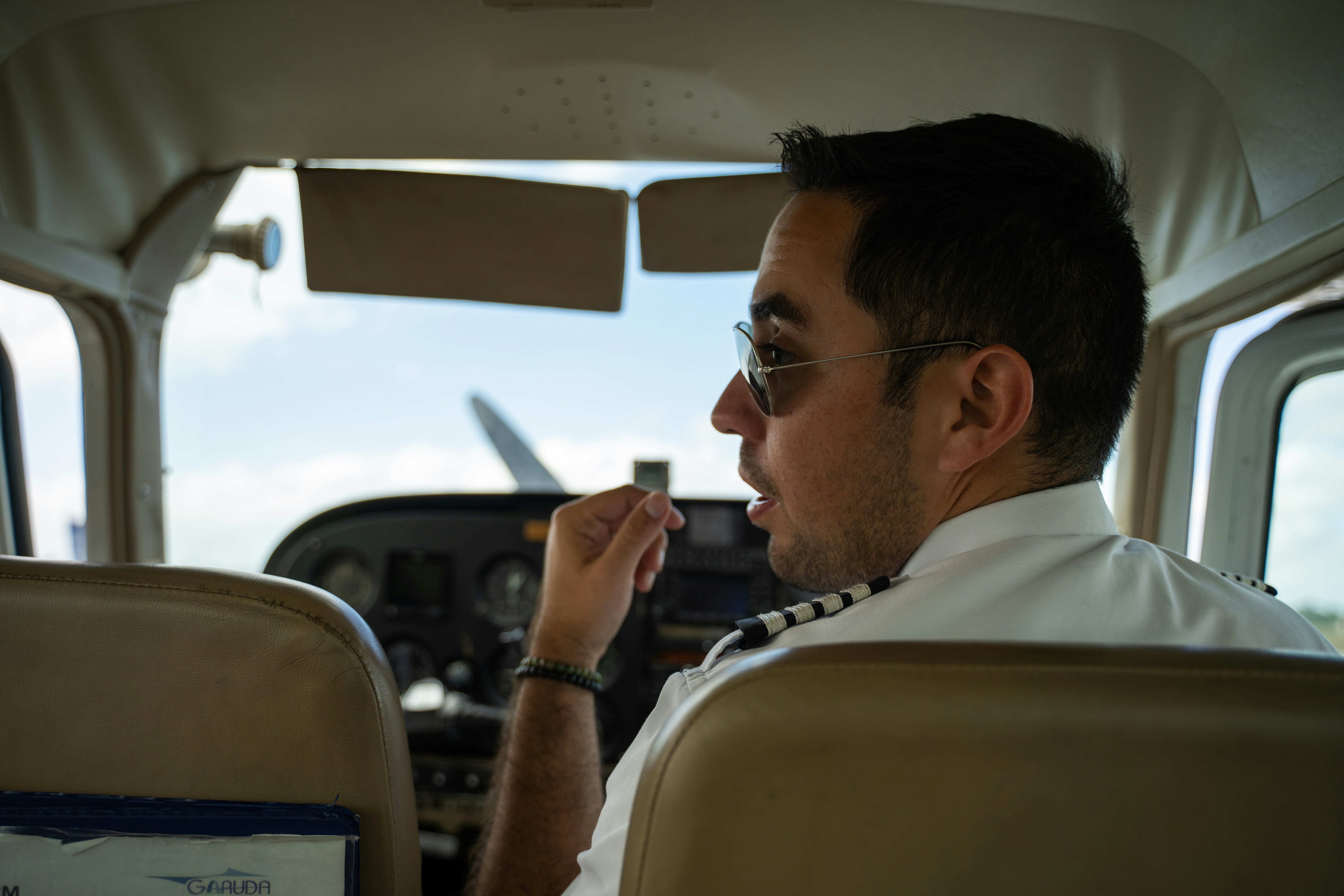 a man sitting in the cockpit of a plane, 