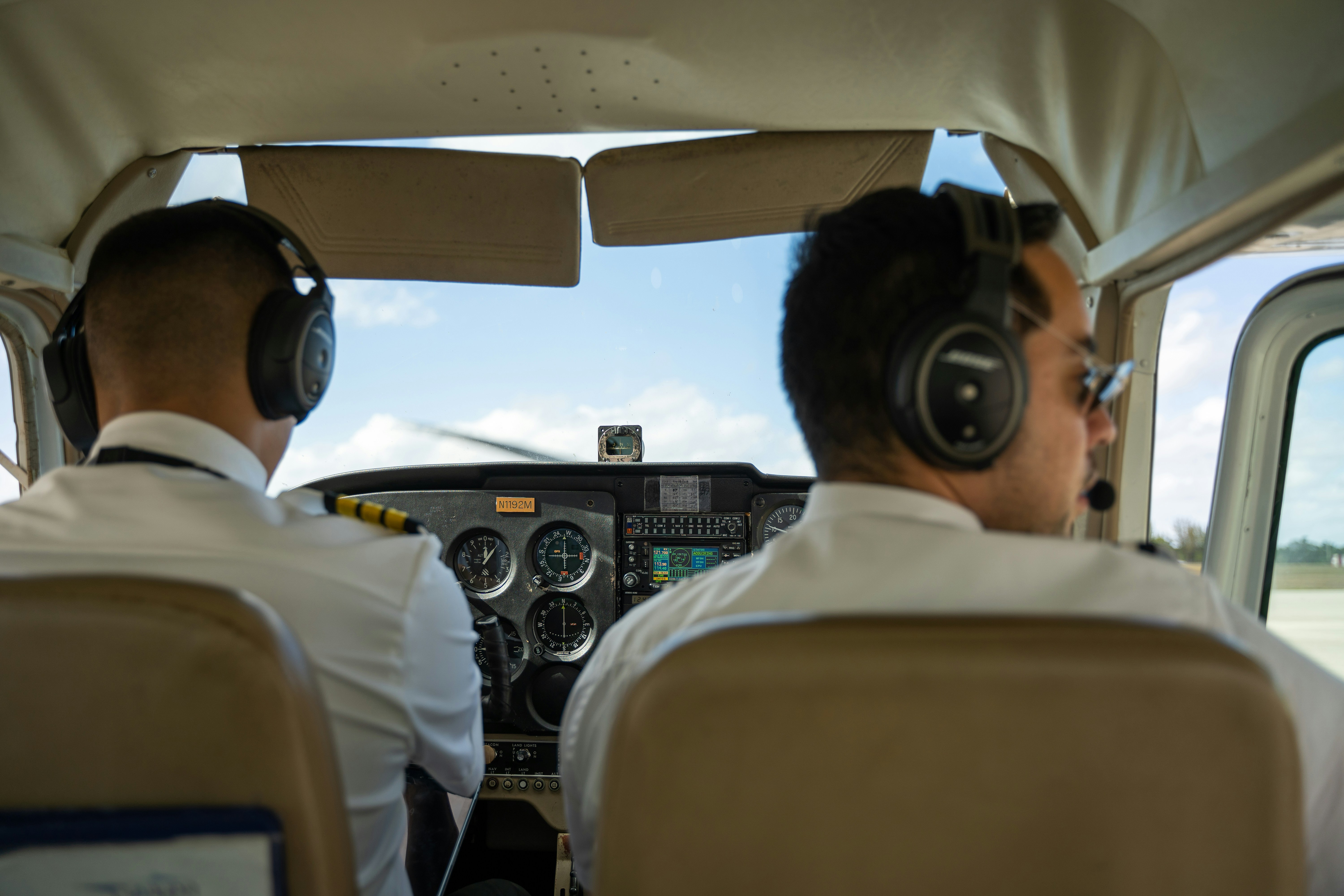 two pilots sitting in the cockpit of a plane, 