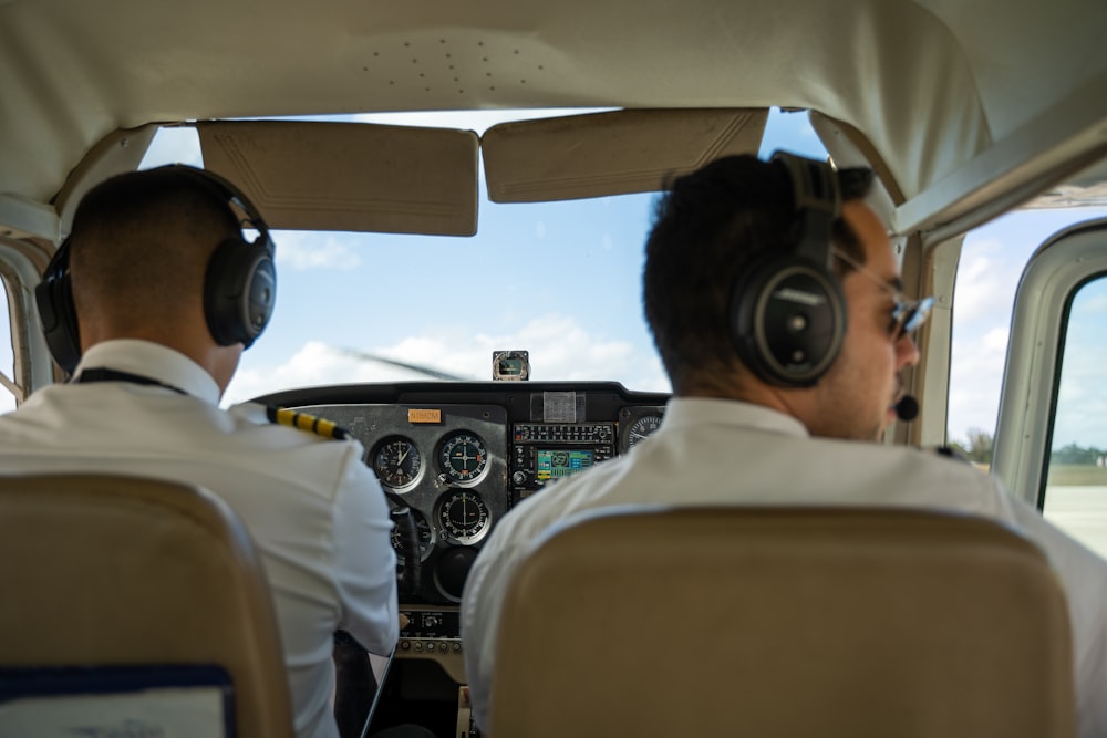 two pilots sitting in the cockpit of a plane