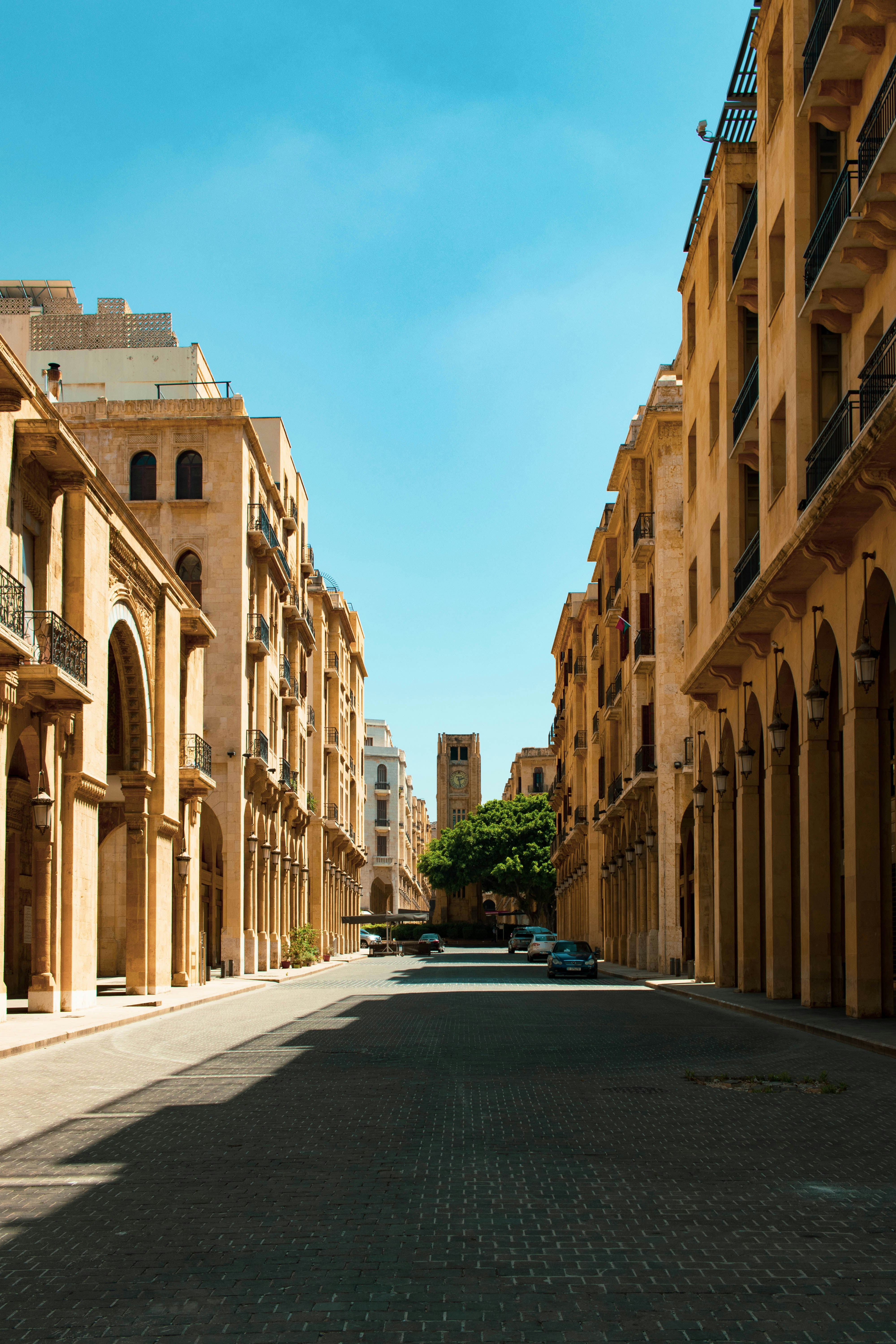 a street lined with buildings and a blue car