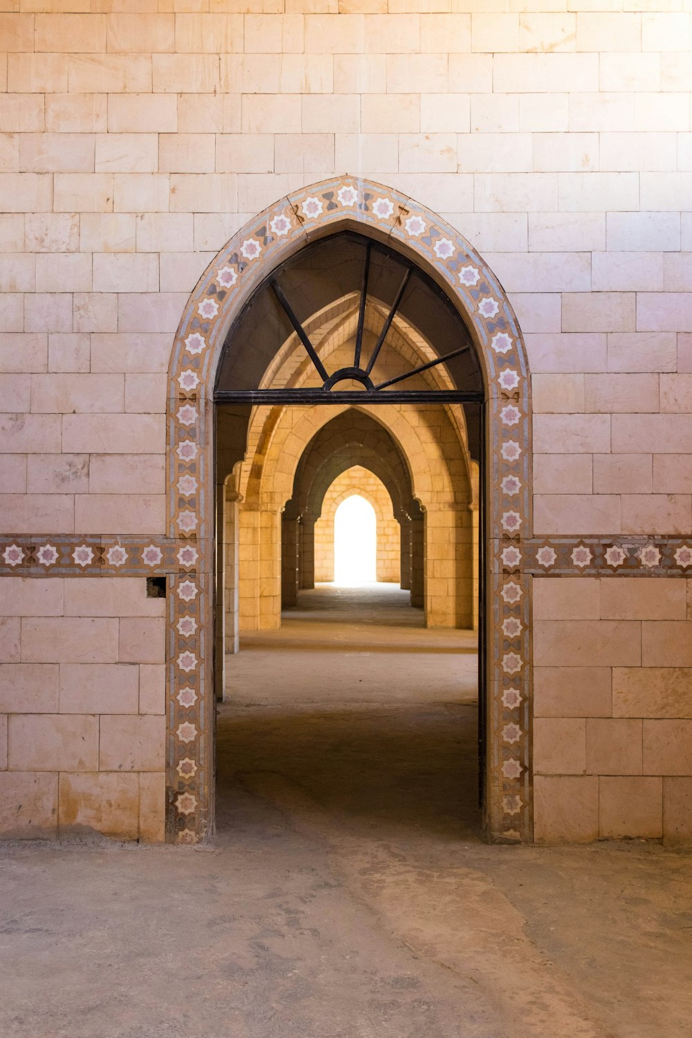 an archway in a building with a clock on the wall