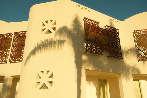 Exterior wall coated with heat reflective paint, gleaming under Kerala’s tropical sun.