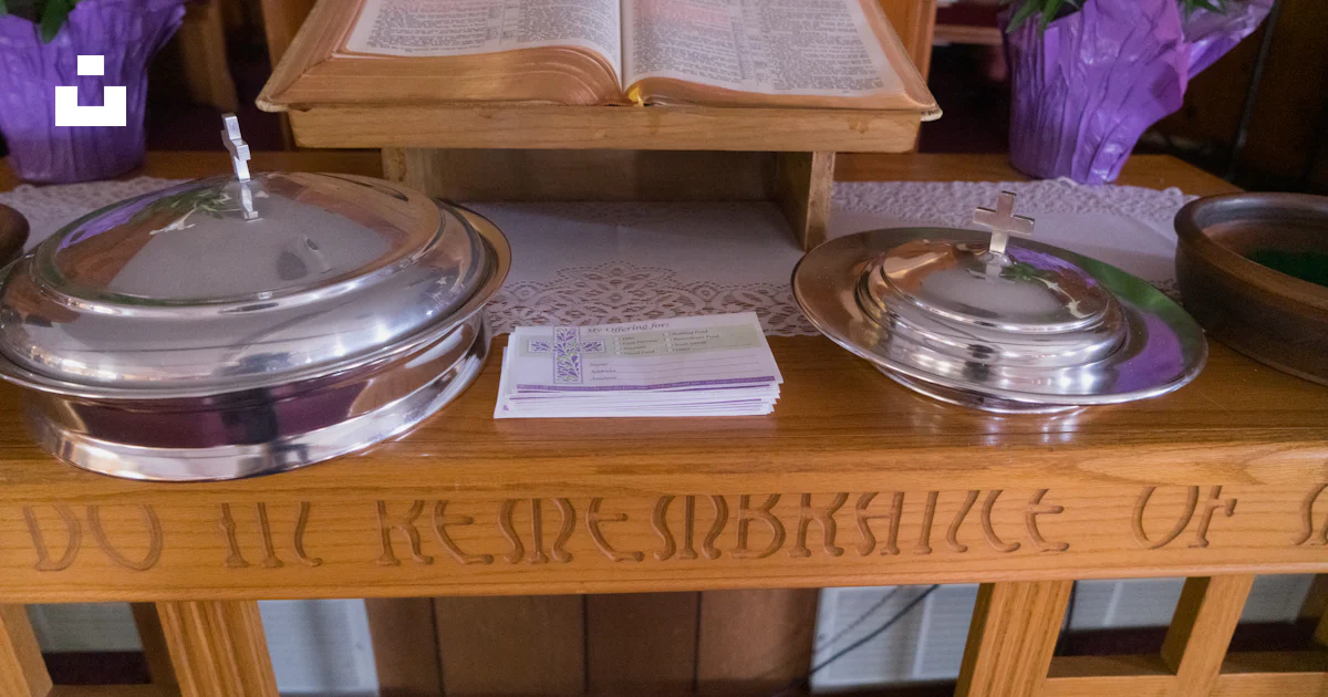 A wooden table topped with two silver covered dishes photo – Free ...